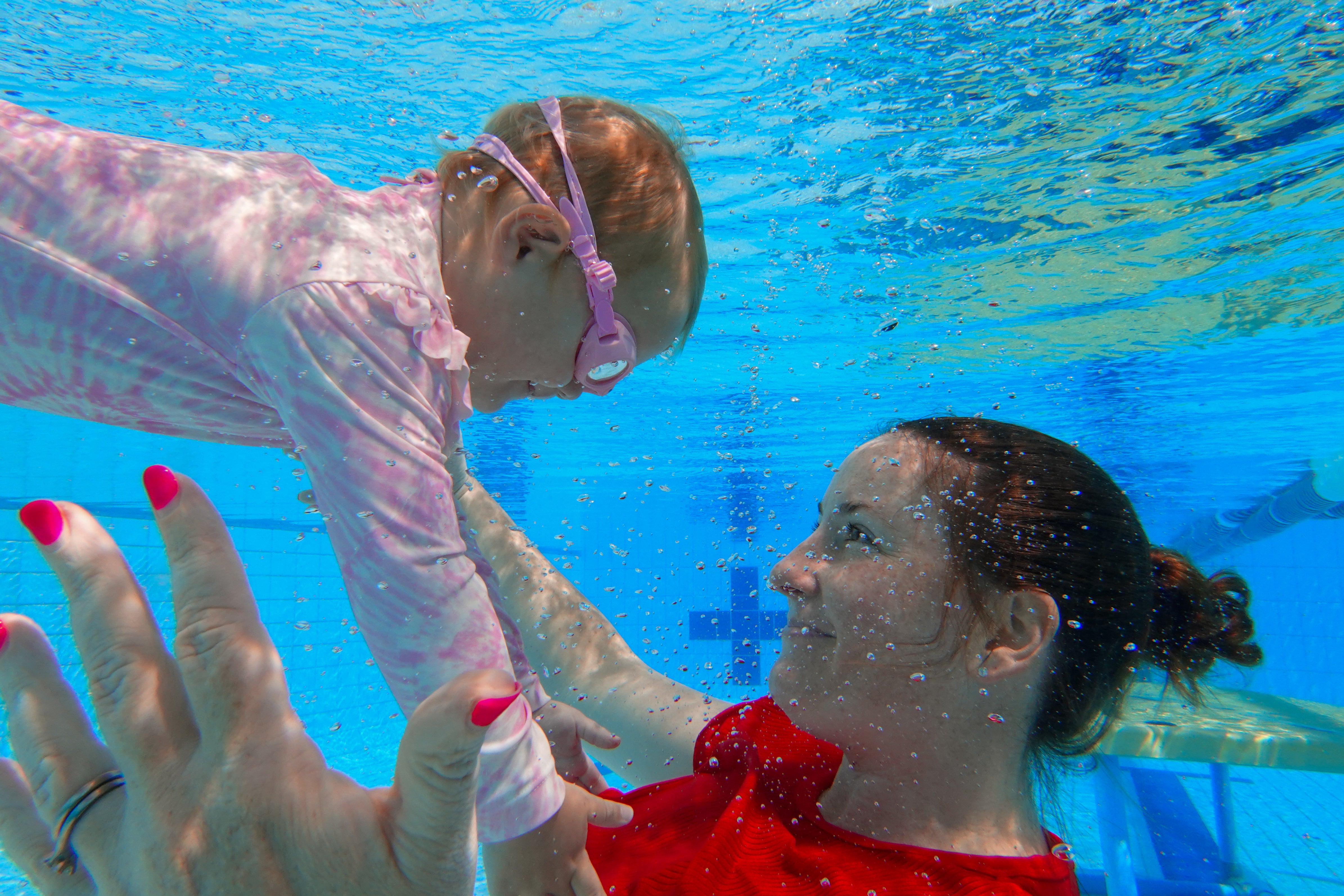 Parent swimming with baby